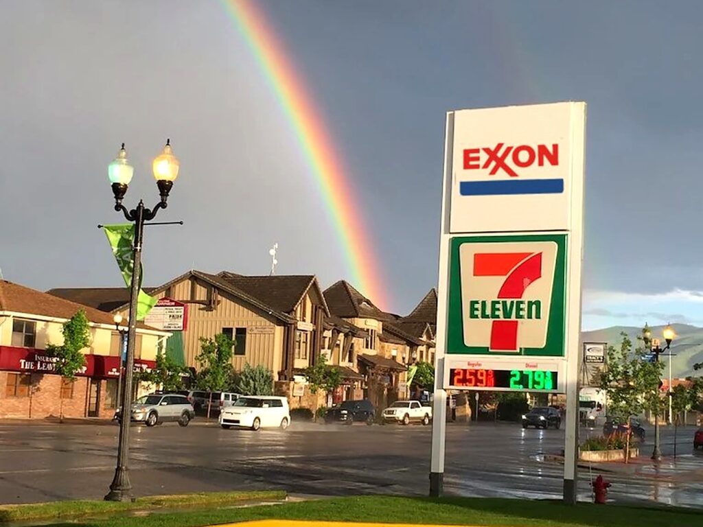 Resort Retailers 7-Eleven and Exxon sign under a rainbow